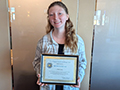  Kenmore West student Sierra Green smiles with an award given to her